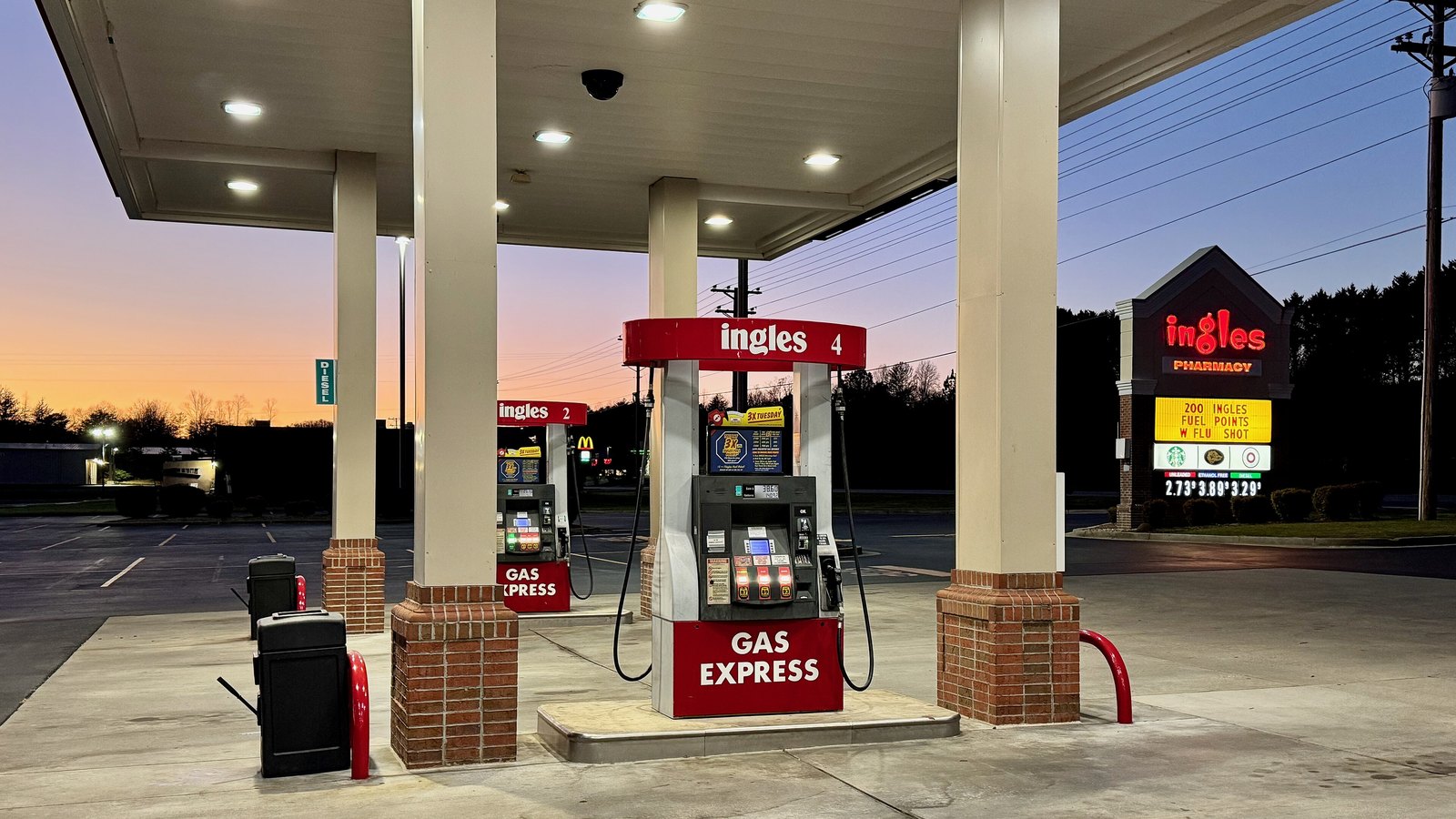 Gasoline pumps at a gas station at sunset