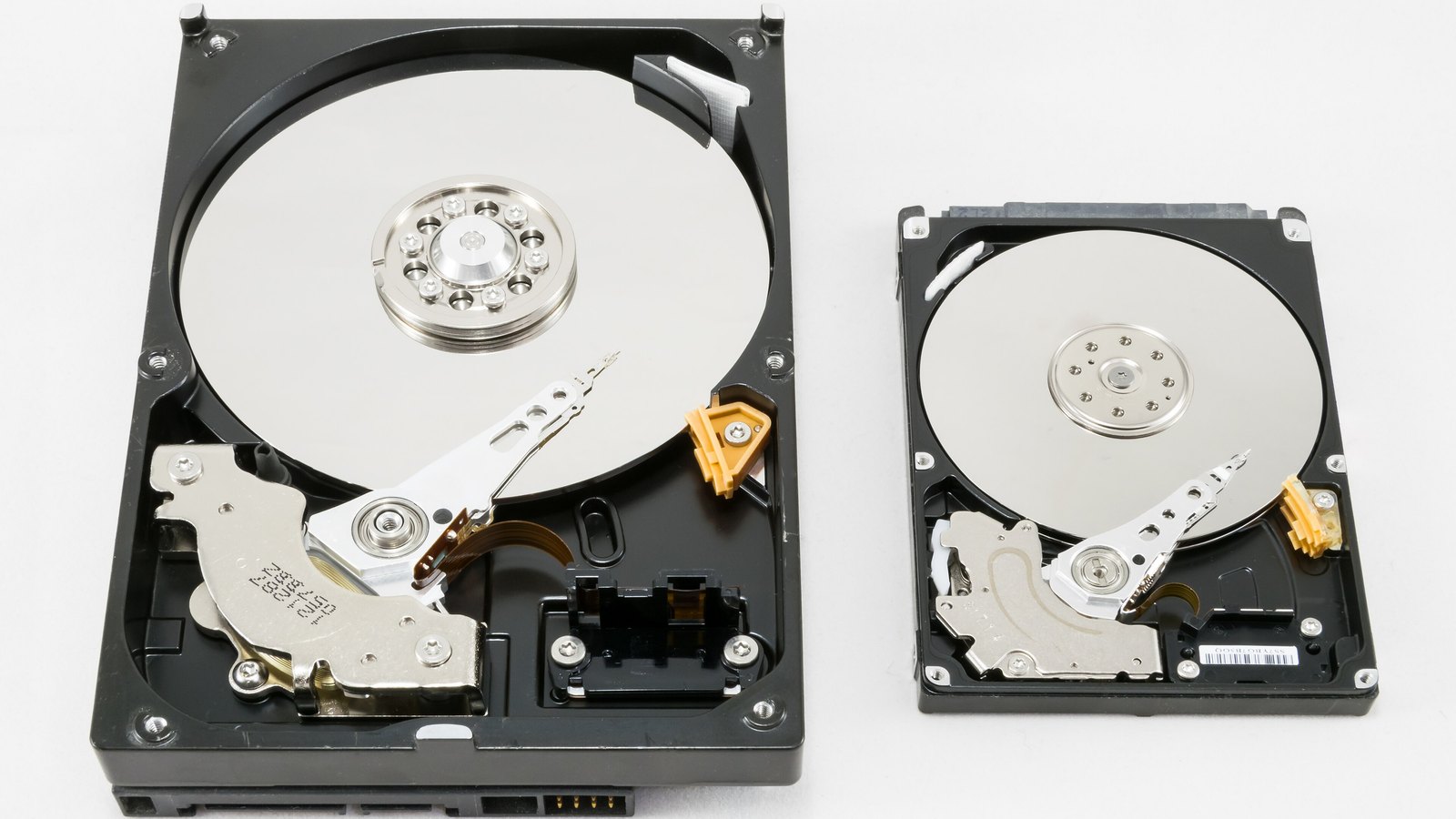 Disassembled hard disk drives showing their platters and read heads