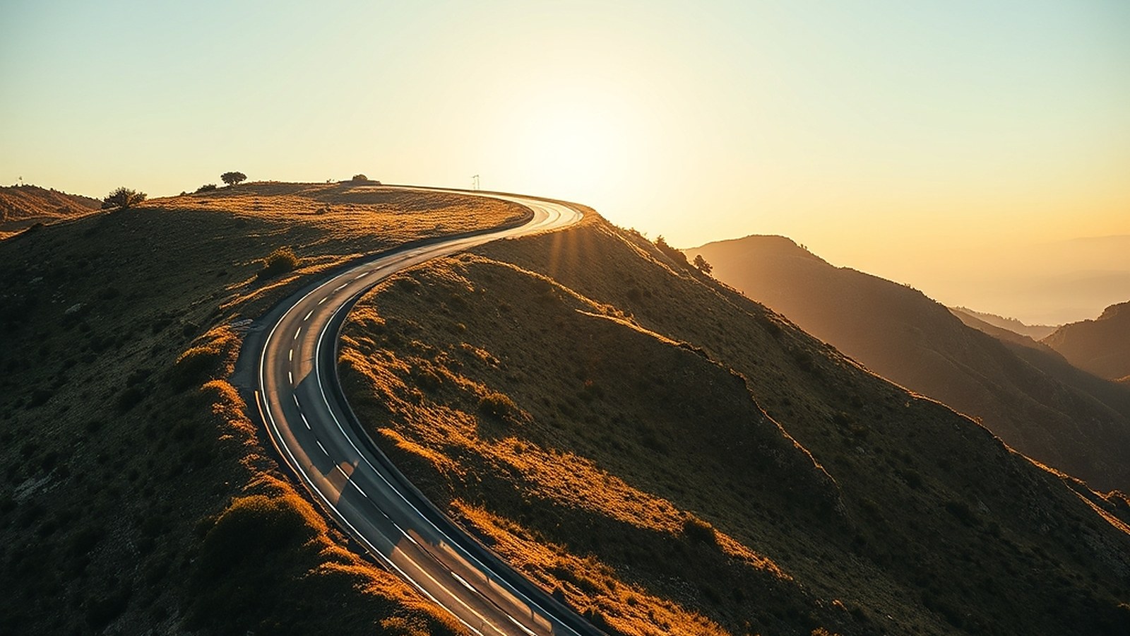 Illustration of a curving road climbing a hillside at sunset