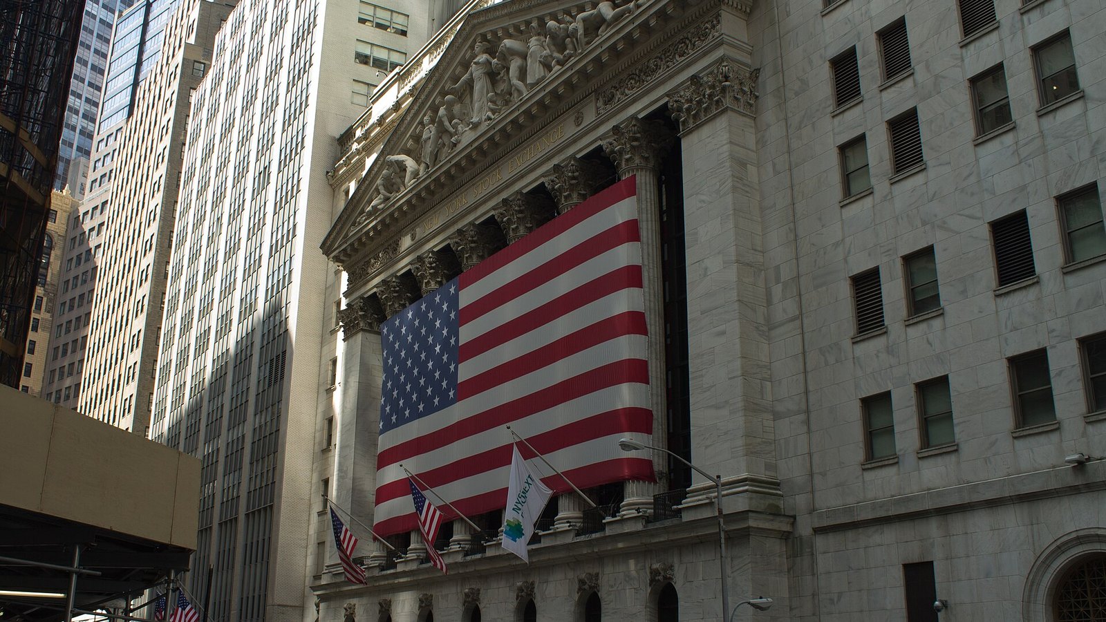 American flag hanging on the facade of the New York Stock Exchange on Wall Street
